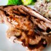 Bone-in pork chops are marinated in maple syrup and mustard to produce a savory-sweet flavor.