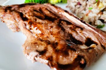 Bone-in pork chops are marinated in maple syrup and mustard to produce a savory-sweet flavor.