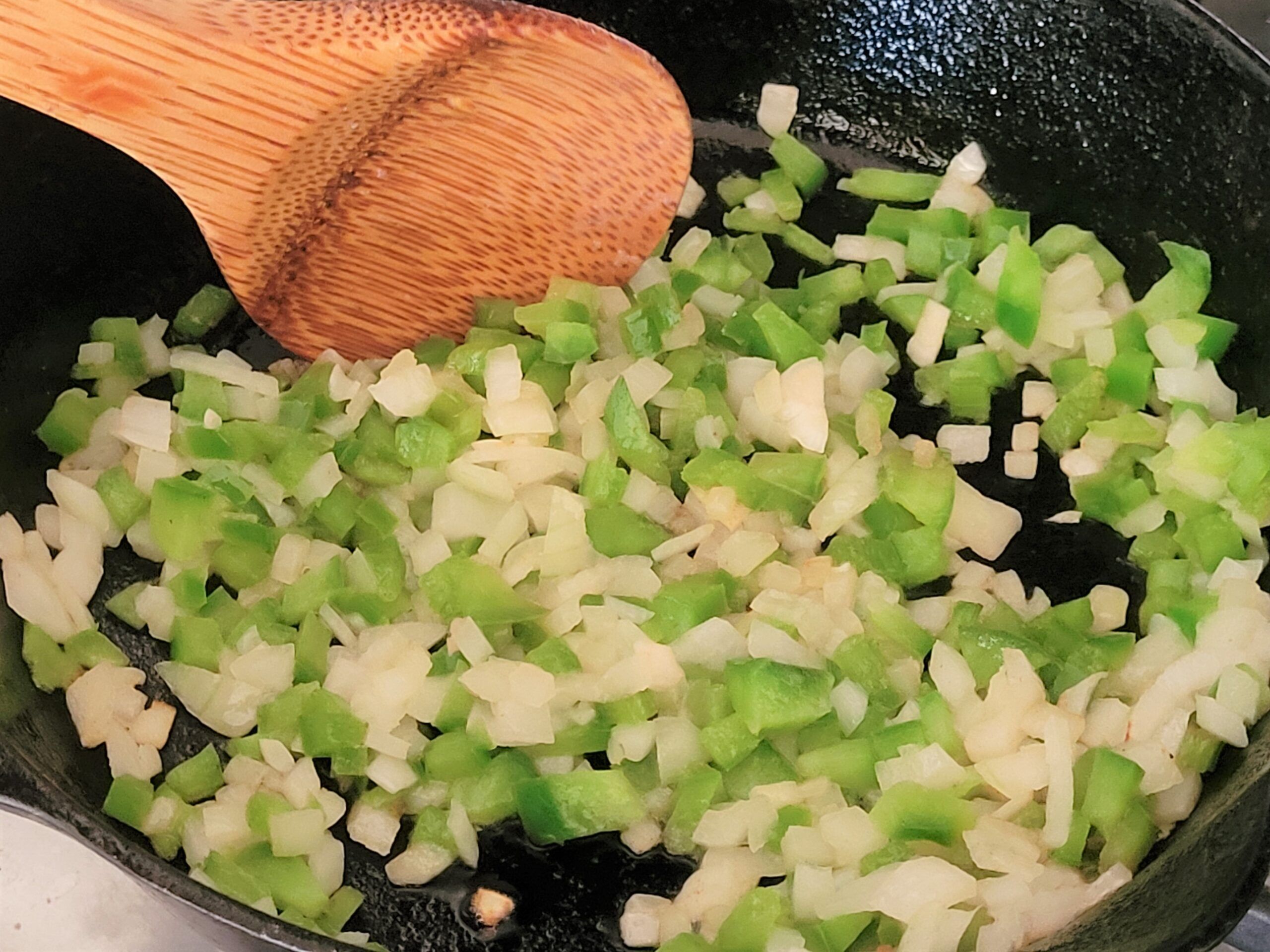 Cook onions and peppers in butter until crisp-tender.