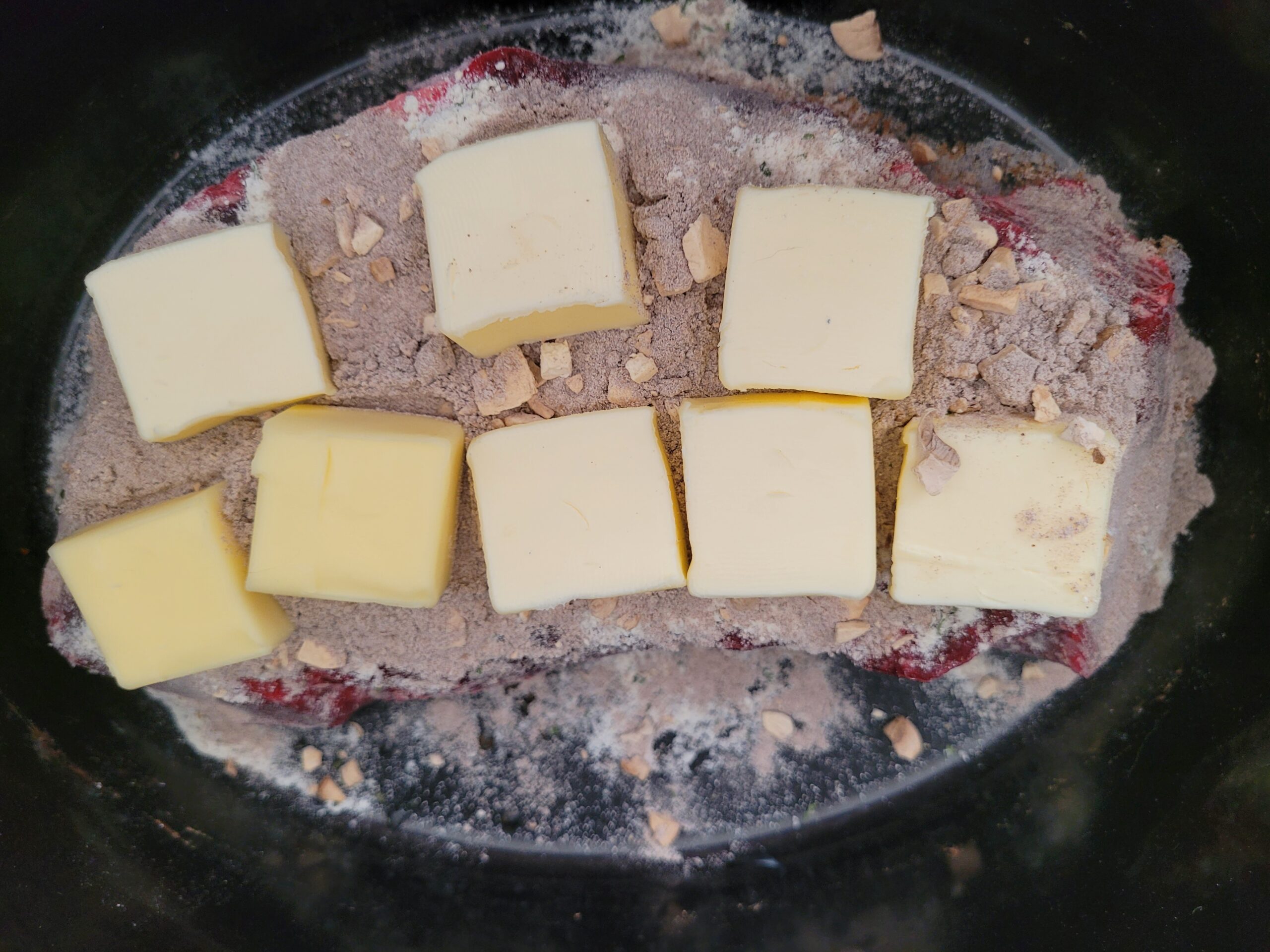 Place tablespoons of butter over meat.