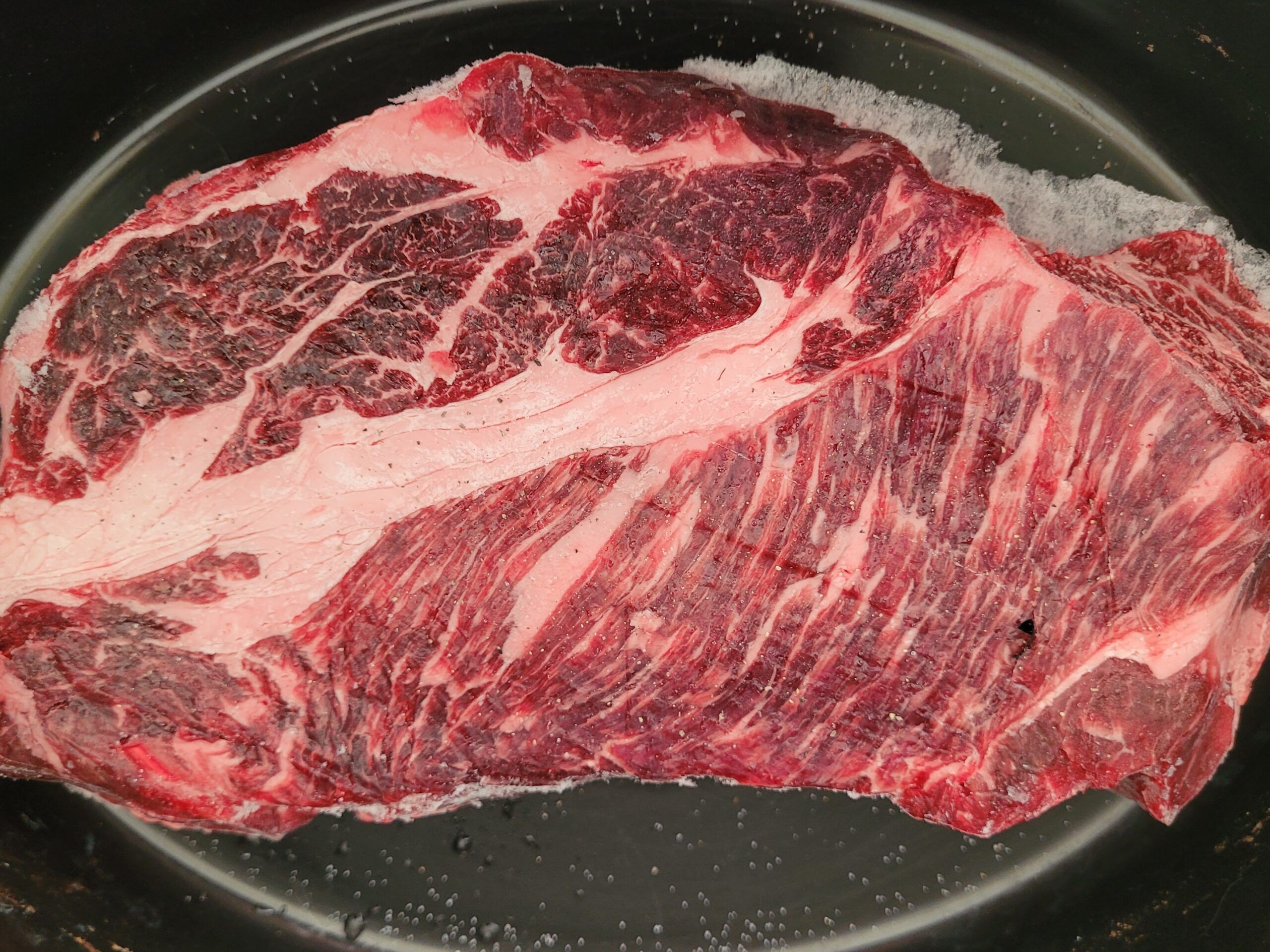 Lay chuck roast in slow cooker and sprinkle with salt and pepper.