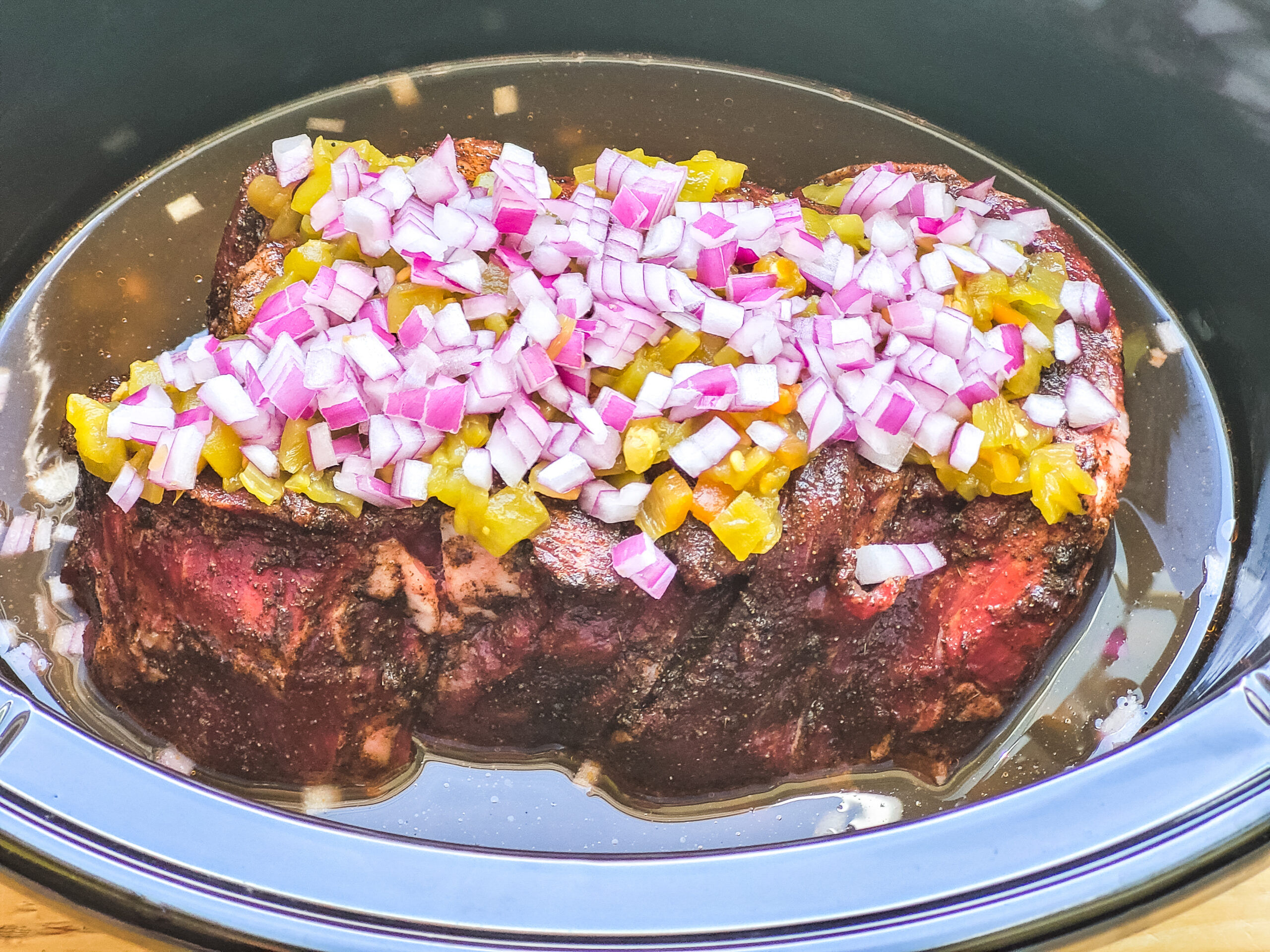 Chuck Roast in Slow Cooker Top roast with onions, garlic, and green chilis.