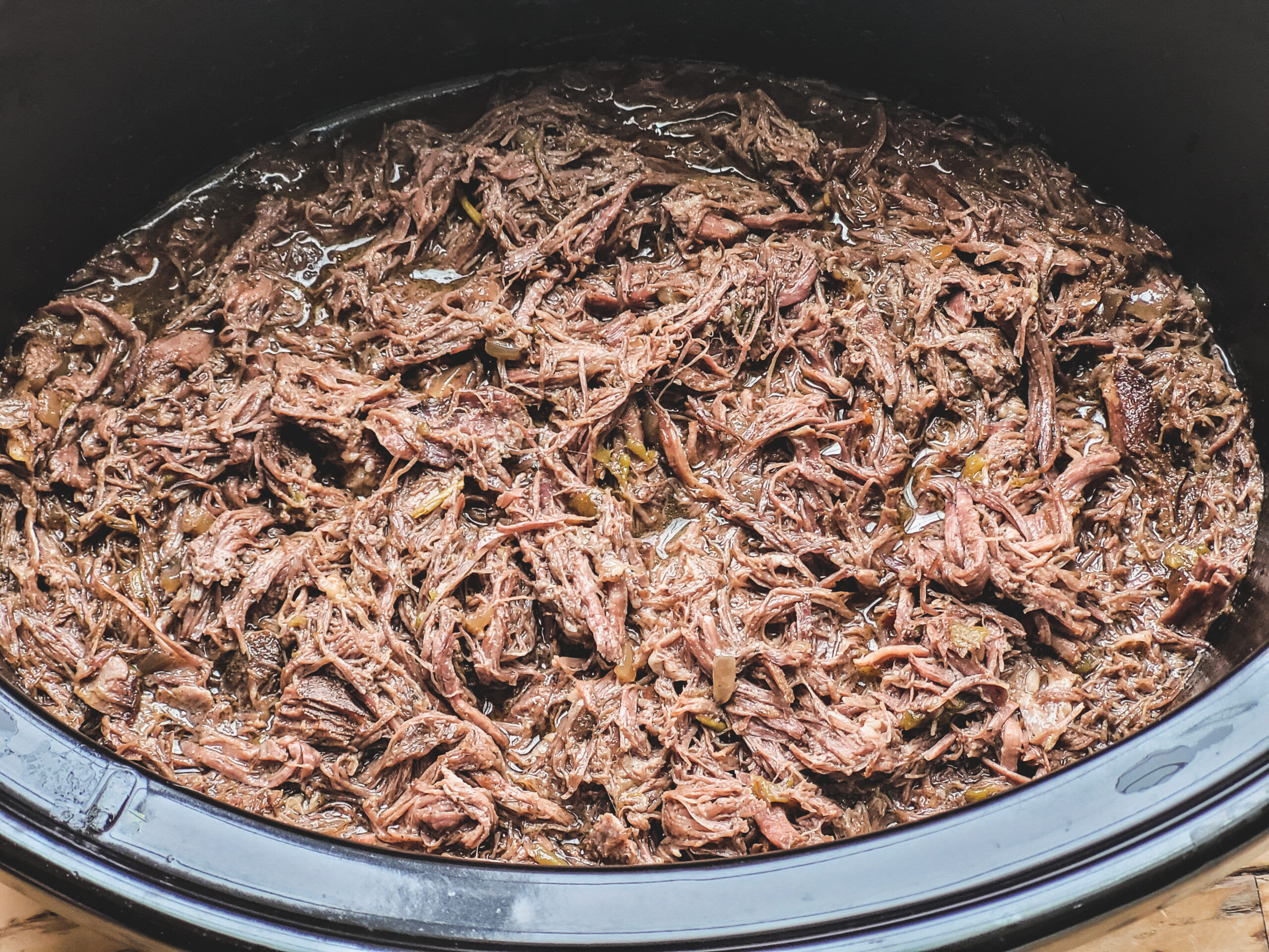 Slow Cooker Beef Carnitas Shred with two forks. Simmer to thicken gravy.
