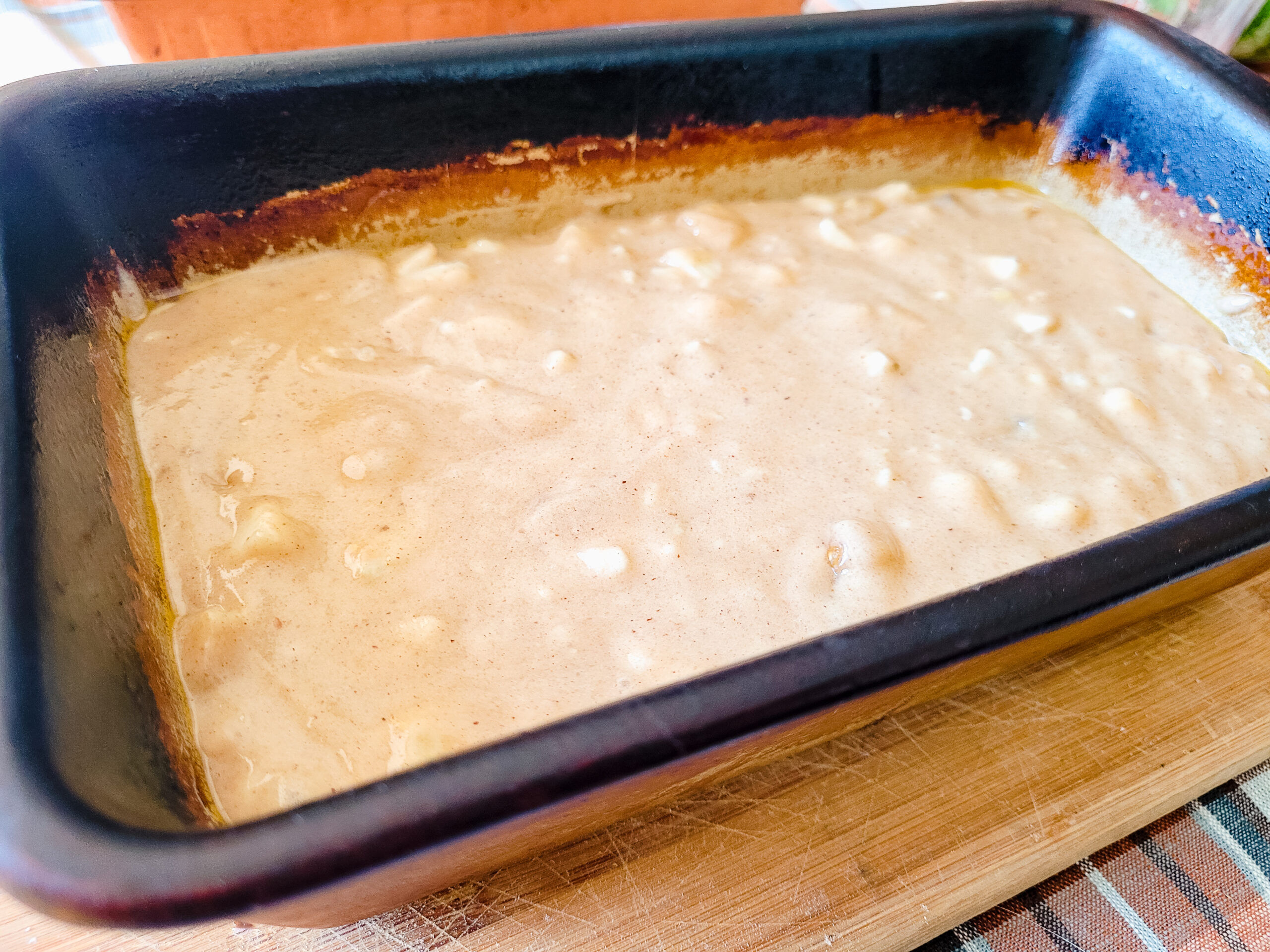 Pour evenly into two greased loaf pans.