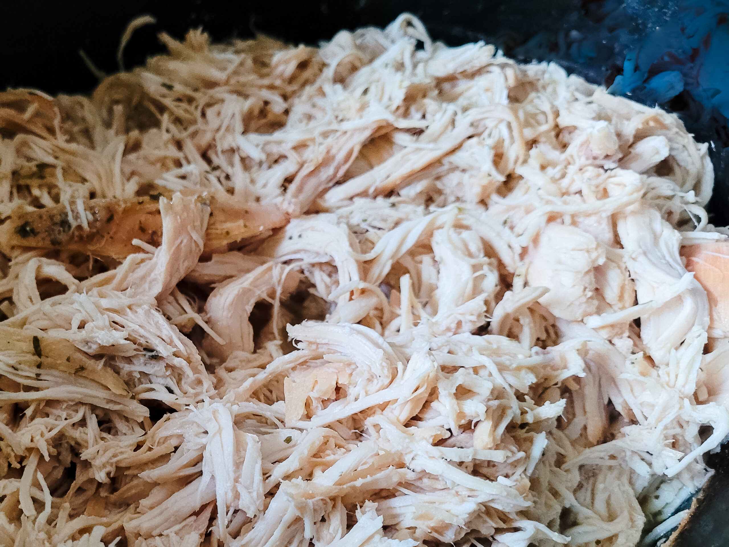 Shred chicken with two forks.