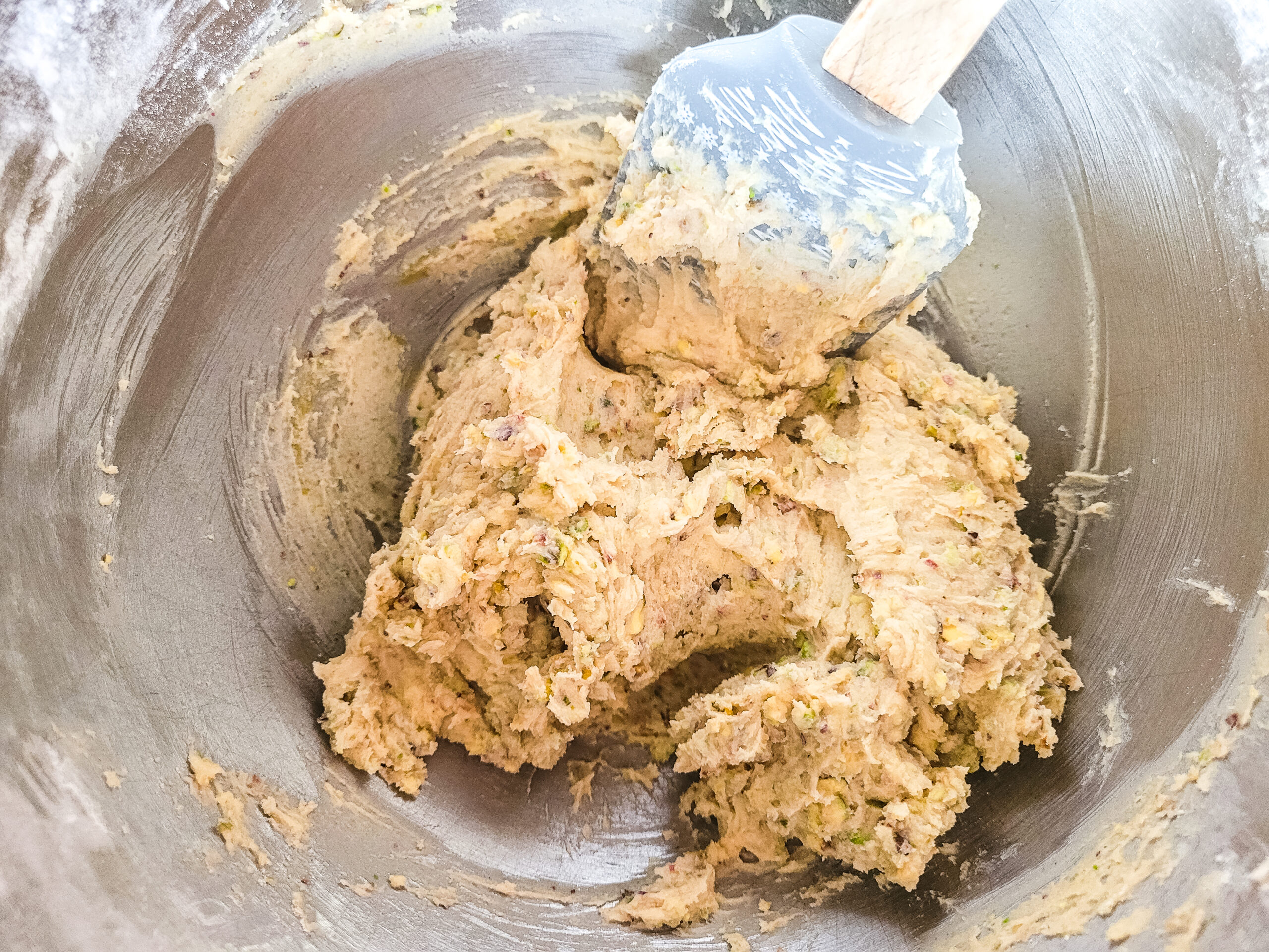 How to Make Pistachio Cookies Add the butter, vanilla, flour, pistachios, and baking powder. Mix until just combined.