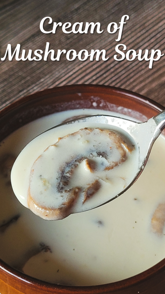 A spoonful of white soup with a single mushroom hovers over a brown bowl of white soup with the words "Cream of Mushroom Soup" over it.